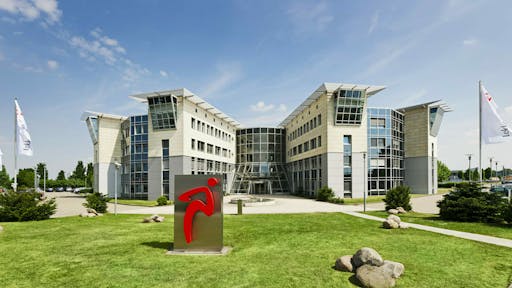 Image of the Lekkerland headquarters, a modern office building with many windows and sloped roofs.