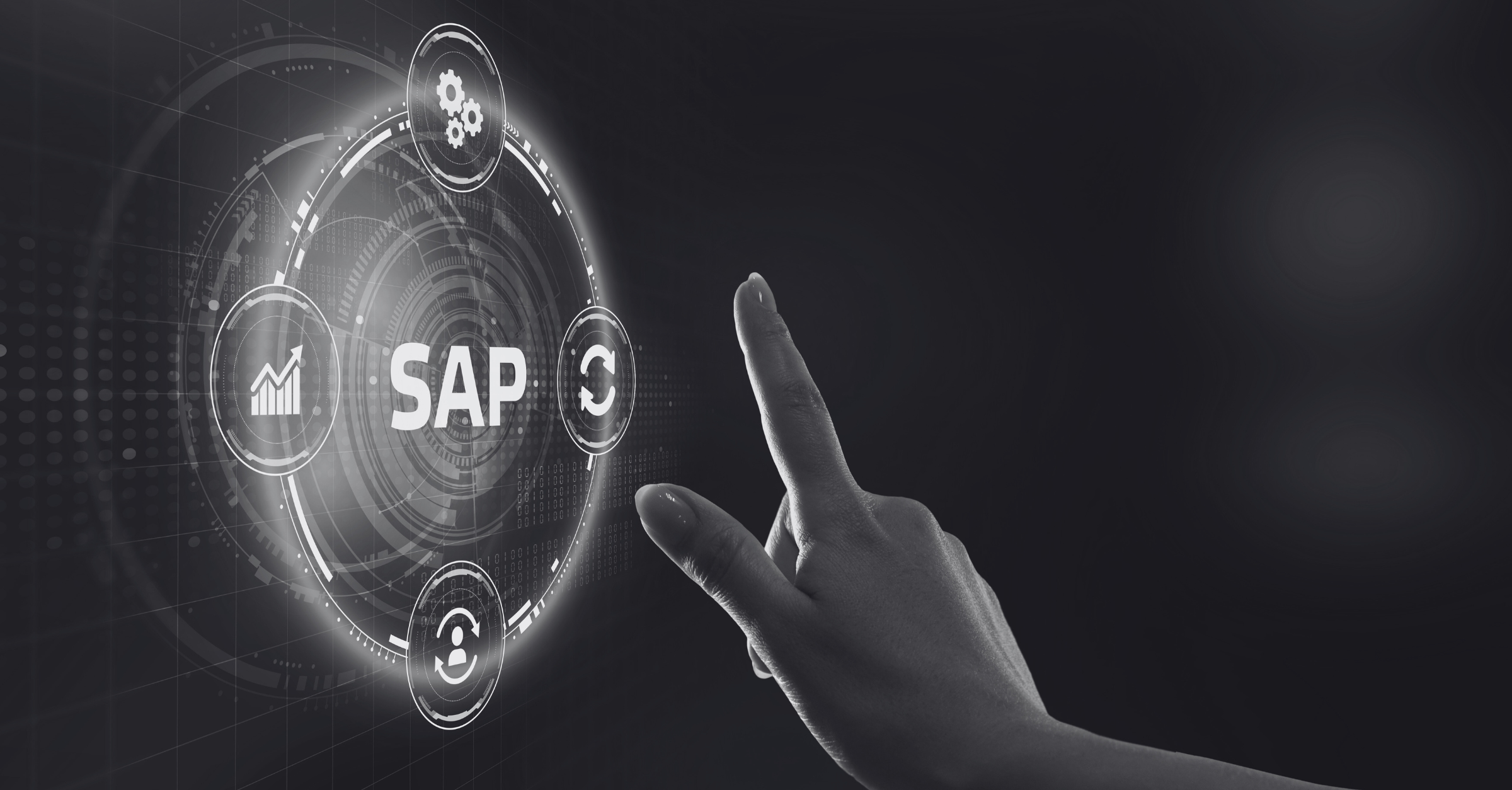 A black-and-white image of a user's hand interacting with a touchscreen interface for SAP software, representing digital process automation and enterprise resource planning in a modern business environment.

