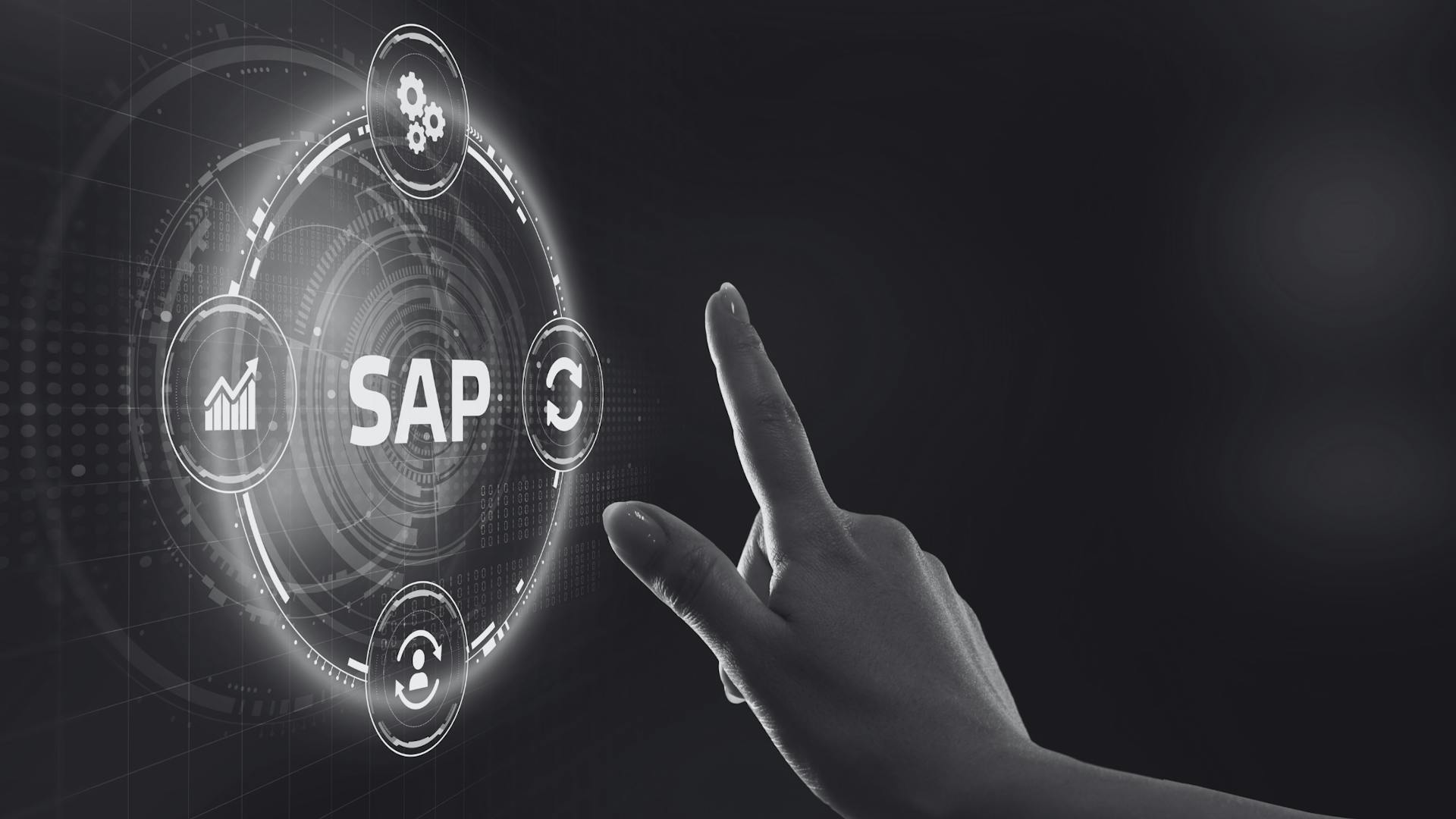 A black-and-white image of a user's hand interacting with a touchscreen interface for SAP software, representing digital process automation and enterprise resource planning in a modern business environment.
 A black-and-white image of a user's hand interacting with a touchscreen interface for SAP software, representing digital process automation and enterprise resource planning in a modern business environment.