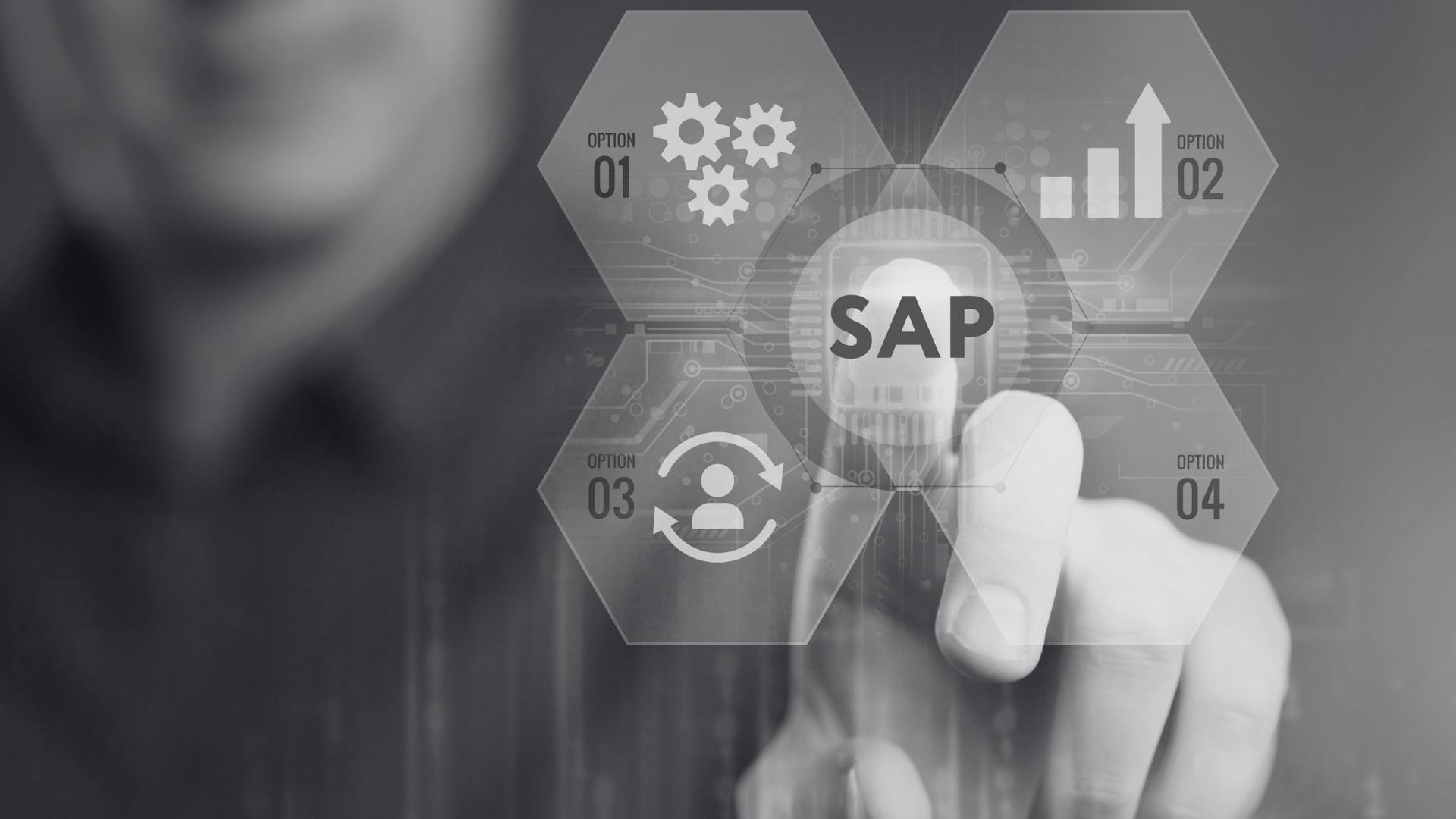 A person is pointing at a virtual touchscreen labeled "SAP" in the center. The word "SAP" is surrounded by four hexagonal icons: a gear, a growth chart, an arrow-bearing user icon, and a fourth option with an unspecified symbol. A person is pointing at a virtual touchscreen labeled "SAP" in the center. The word "SAP" is surrounded by four hexagonal icons: a gear, a growth chart, an arrow-bearing user icon, and a fourth option with an unspecified symbol.