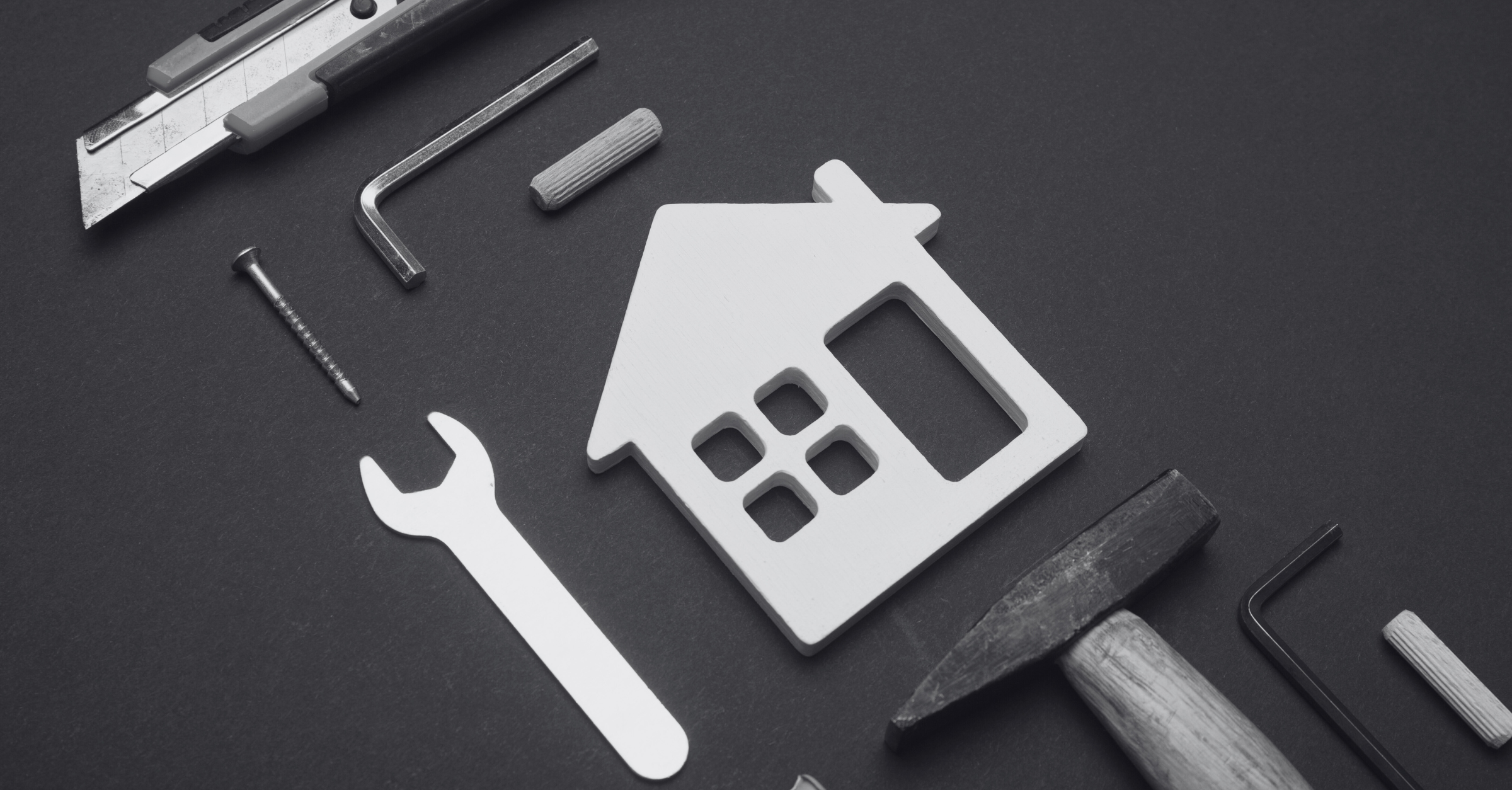 House icon surrounded by tools on a dark background, representing construction and setup. Symbolizes building and integrating digital systems or services.
