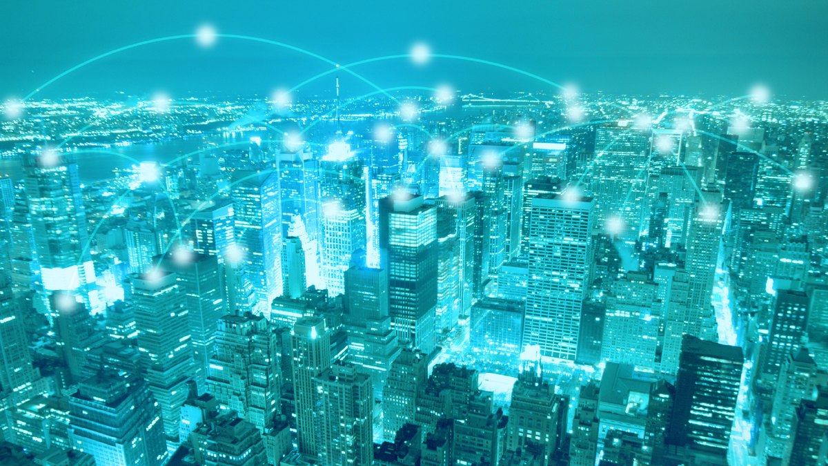 Nighttime city skyline with glowing connection lines showing digital networking and data exchange between buildings.