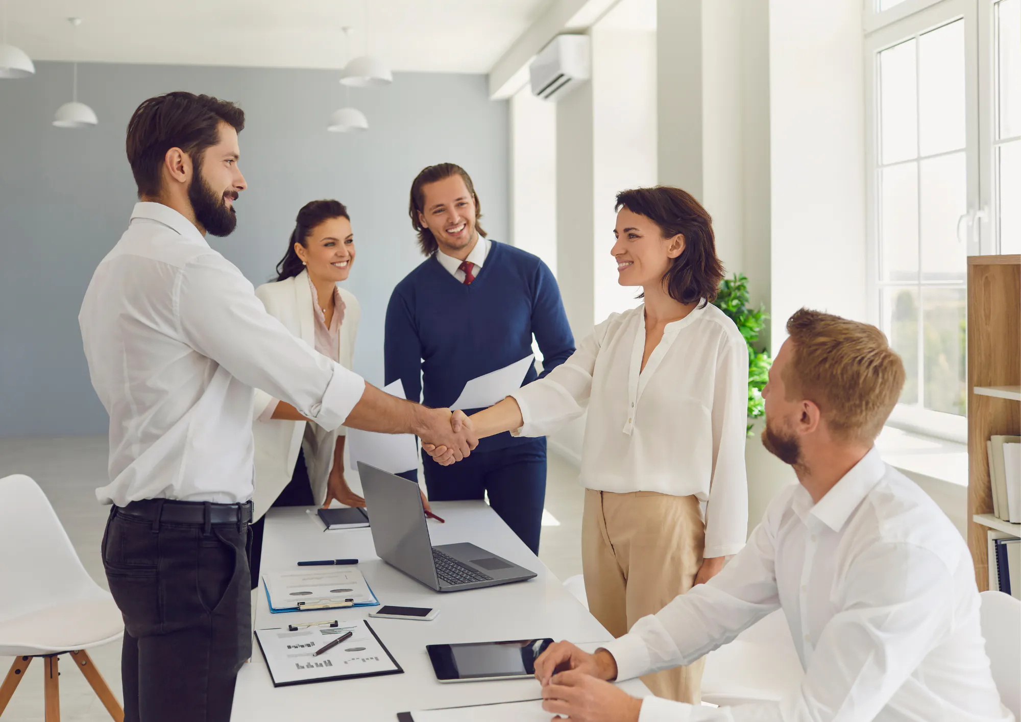 Business partners shaking hands at a meeting