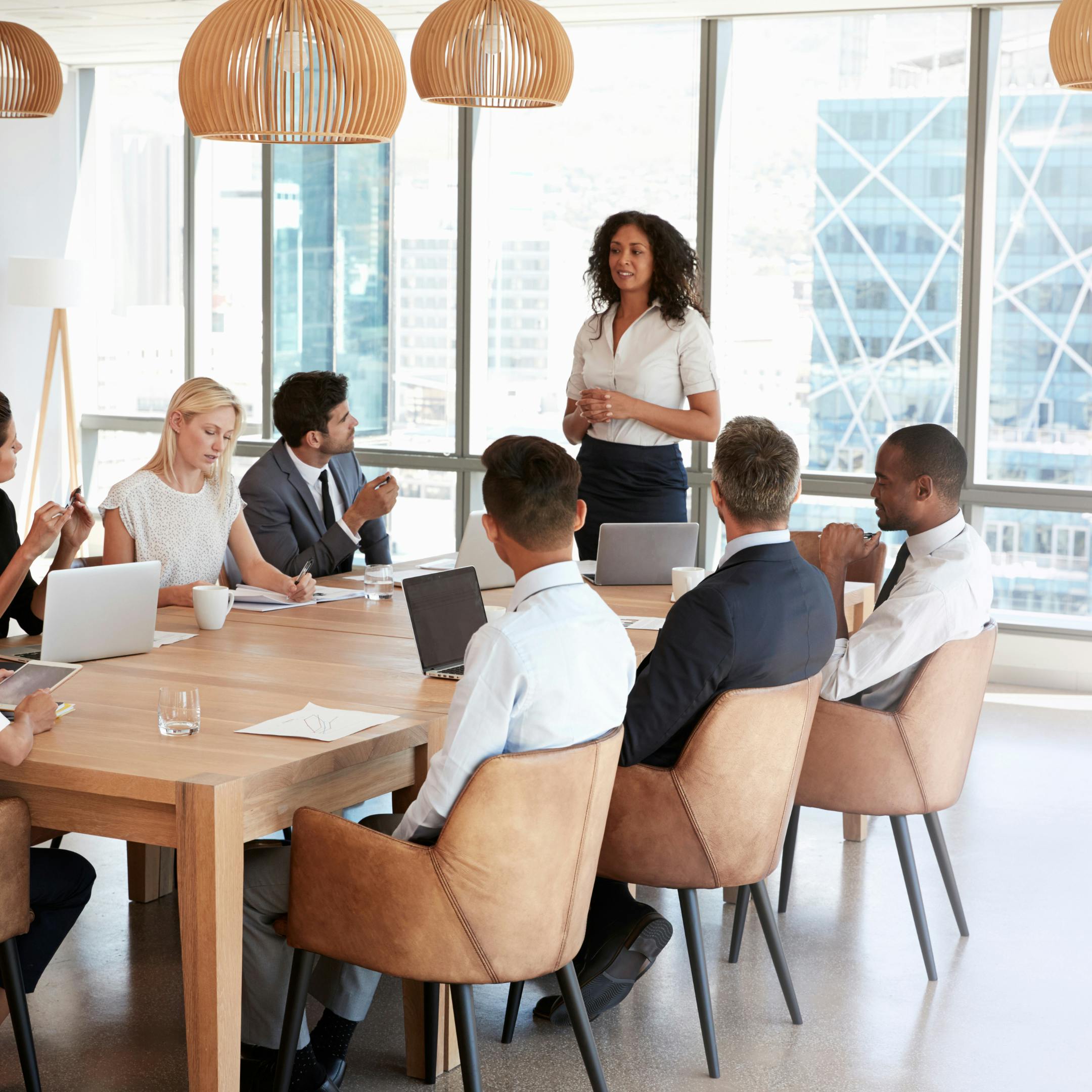 Professional men and women engaged in a business meeting around a conference table