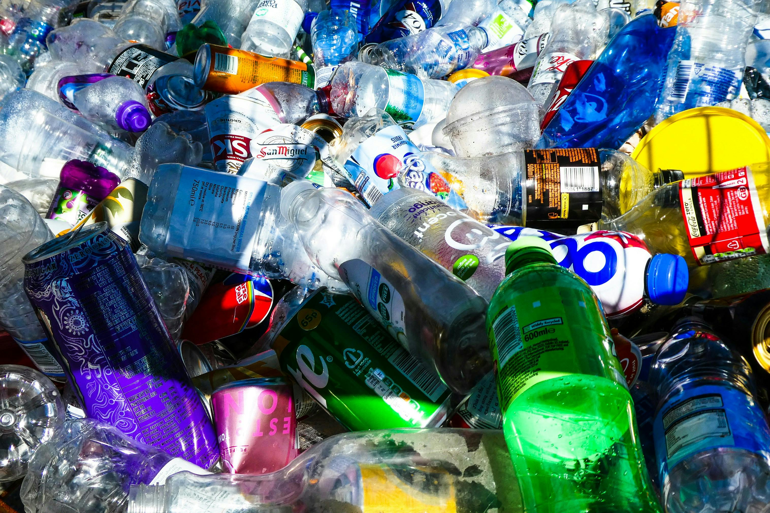 A large pile of plastic bottles and cans showcasing australia's packaging and waste problem.