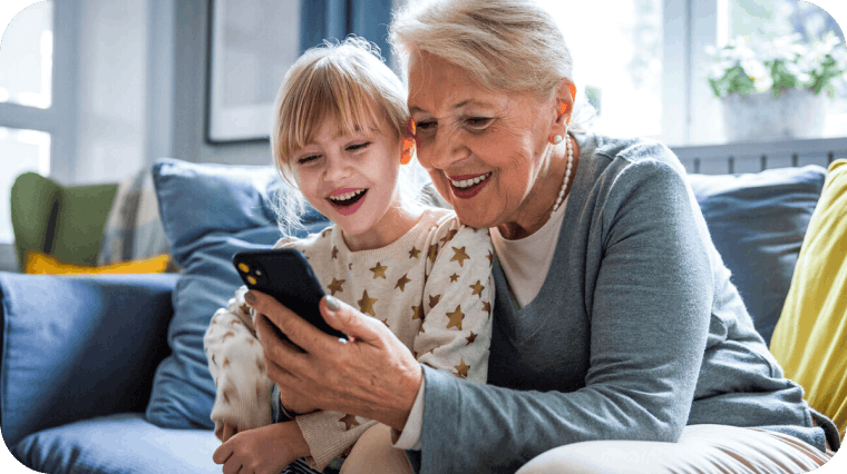 Grandmother sharing her phone with her grandchild