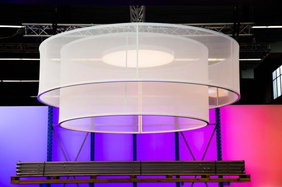 cylindrical fabric frame illuminating an exhibition stand