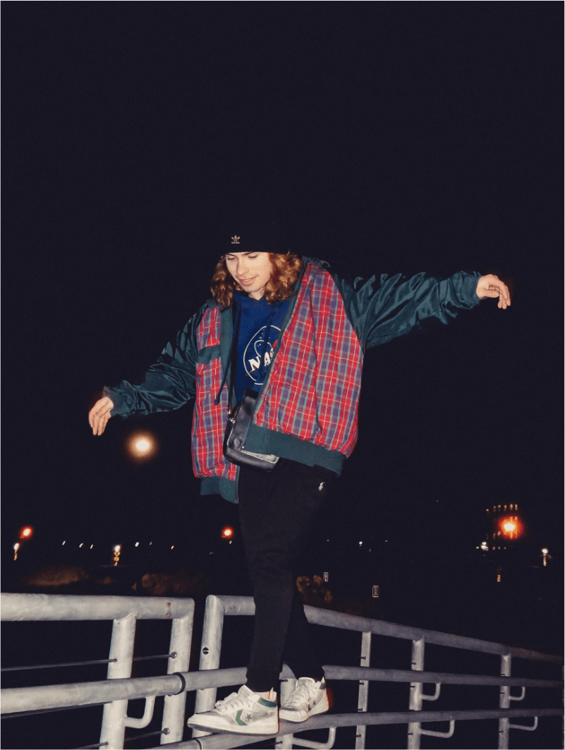 Boy on a fence at night