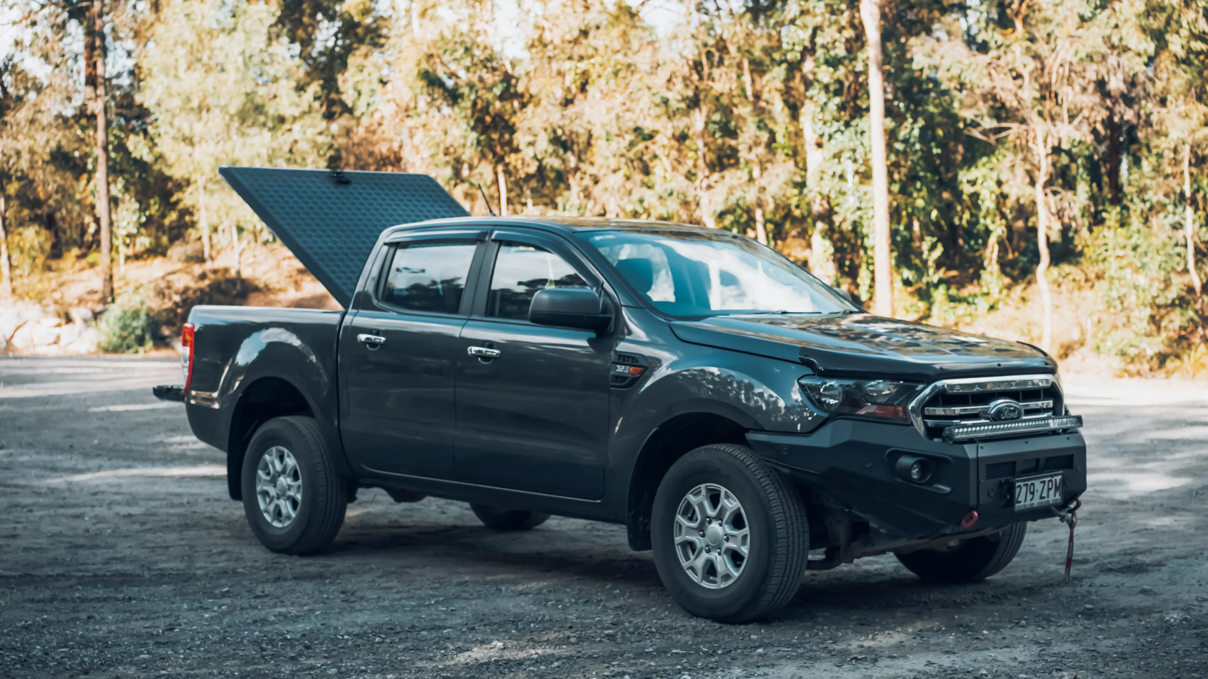 Open EGR Load Shield providing access to the tub of a grey Ute