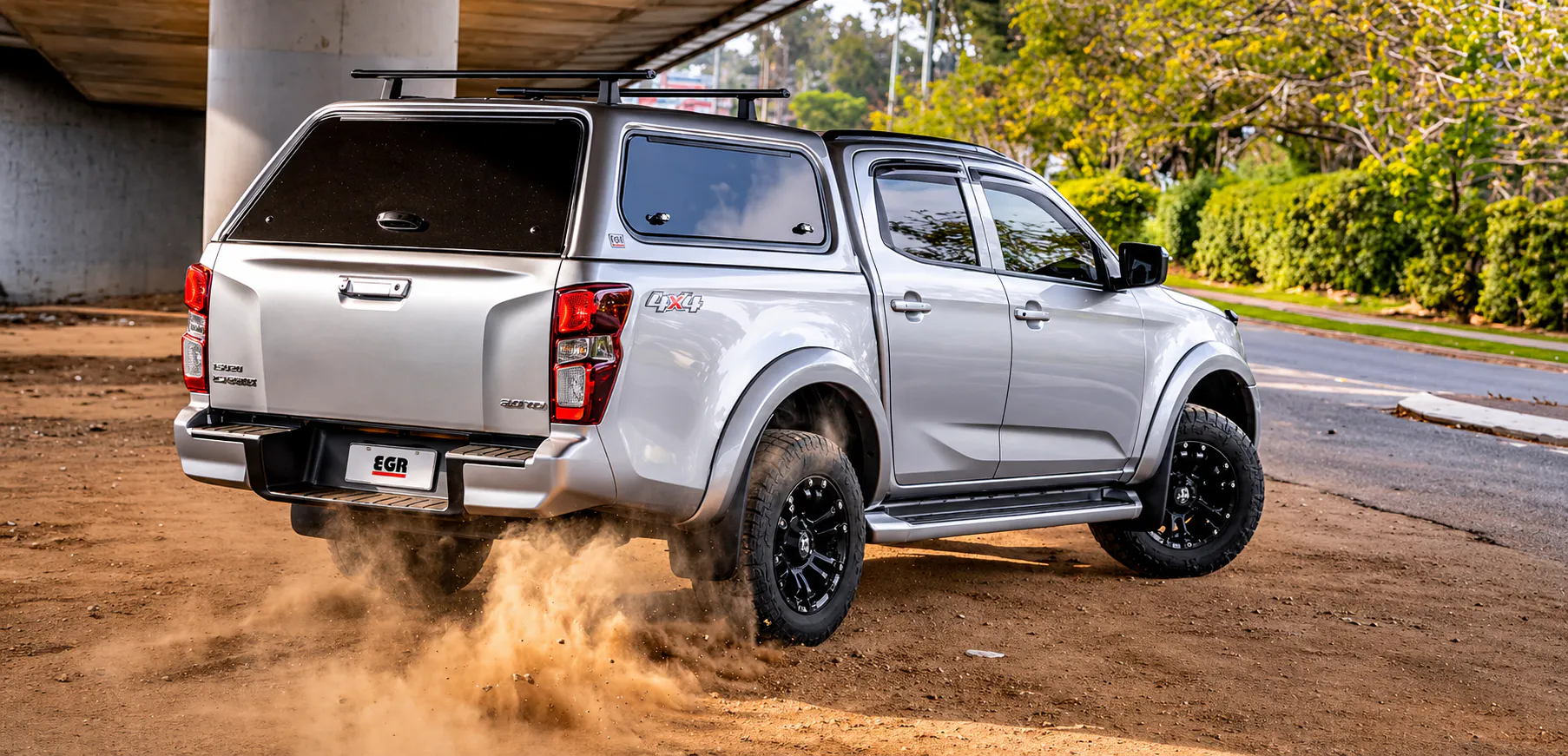 Dual cab ute driving on dusty Australian road