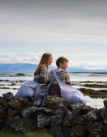 Icelandic children helping with eiderdown collection