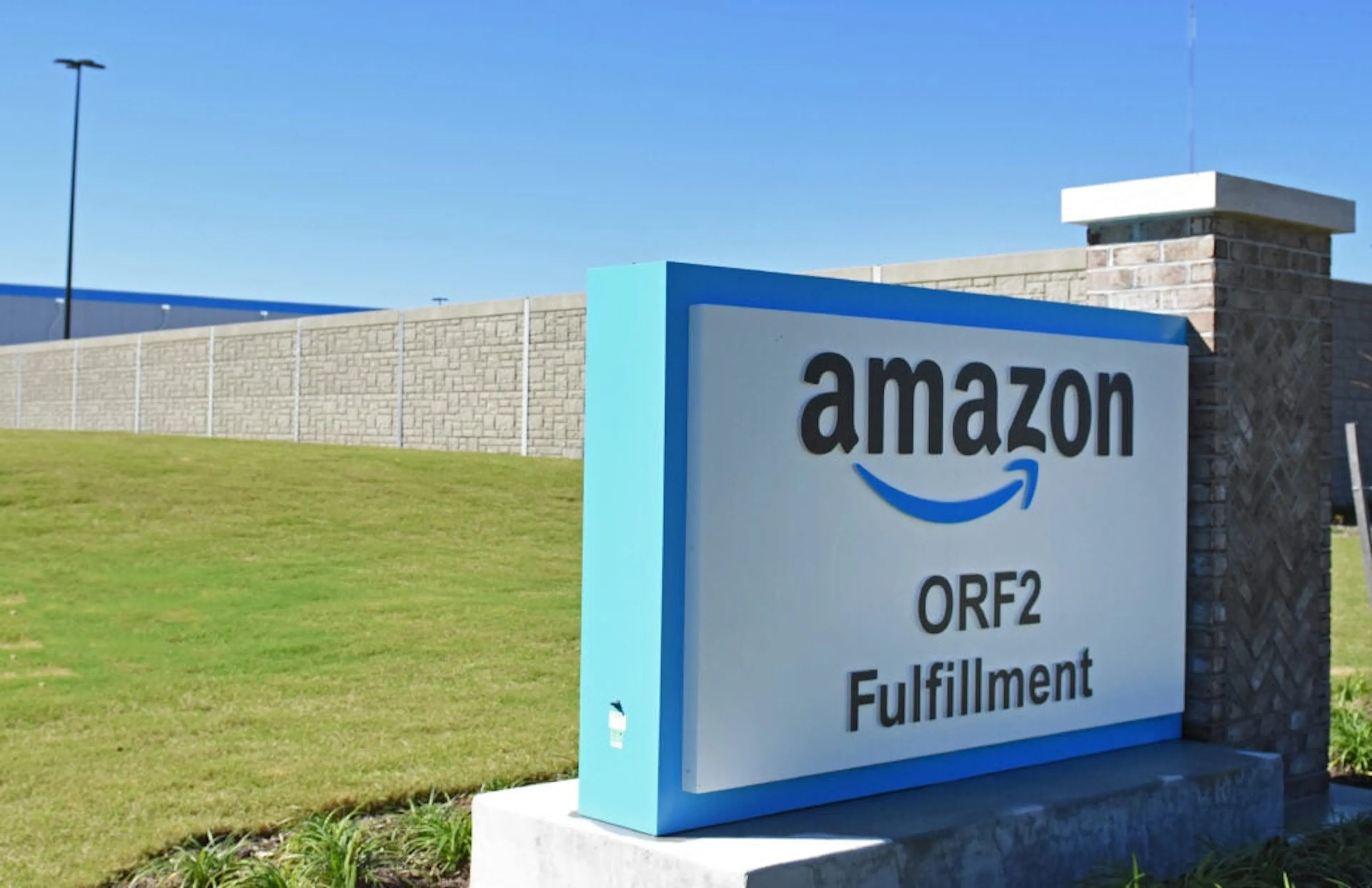 Amazon ORF2 Fulfillment monument sign at the site entrance with the noise wall running behind it