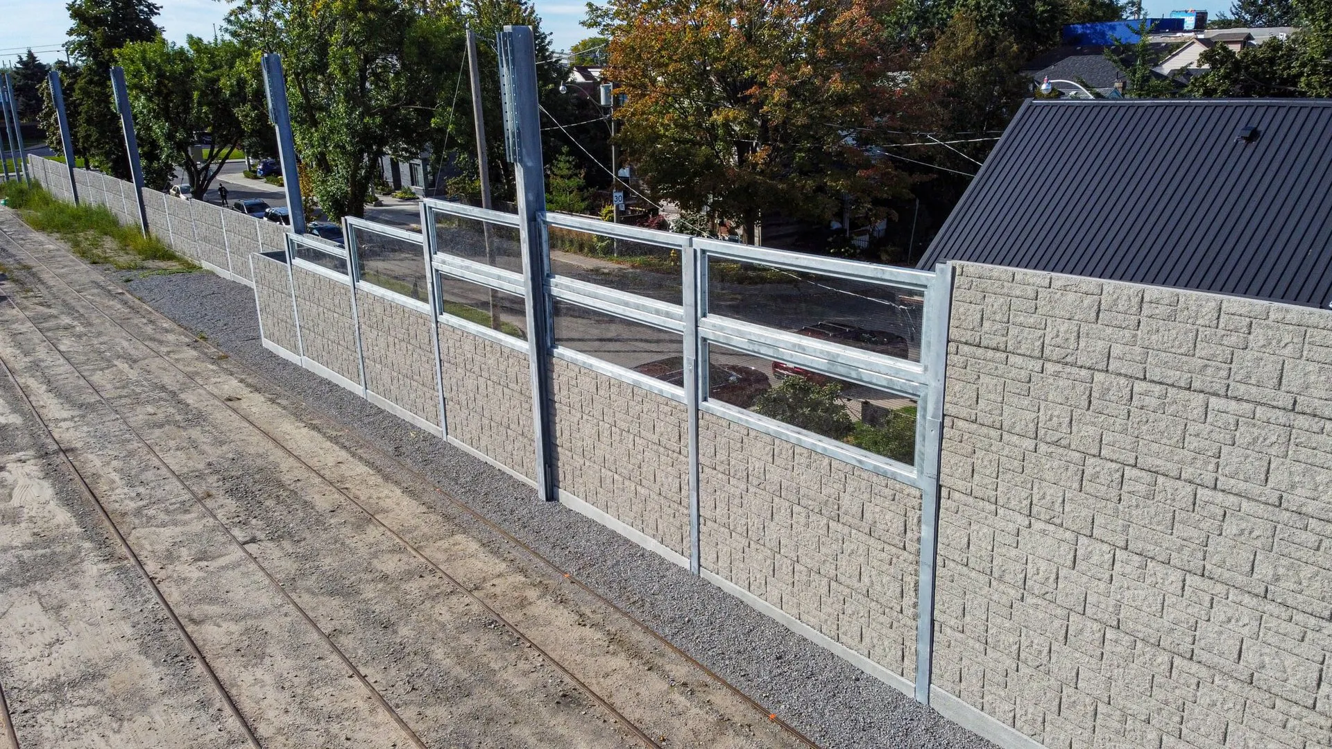 Precast acoustic wall topped with clear panels following the track approach into the Russell Carhouse