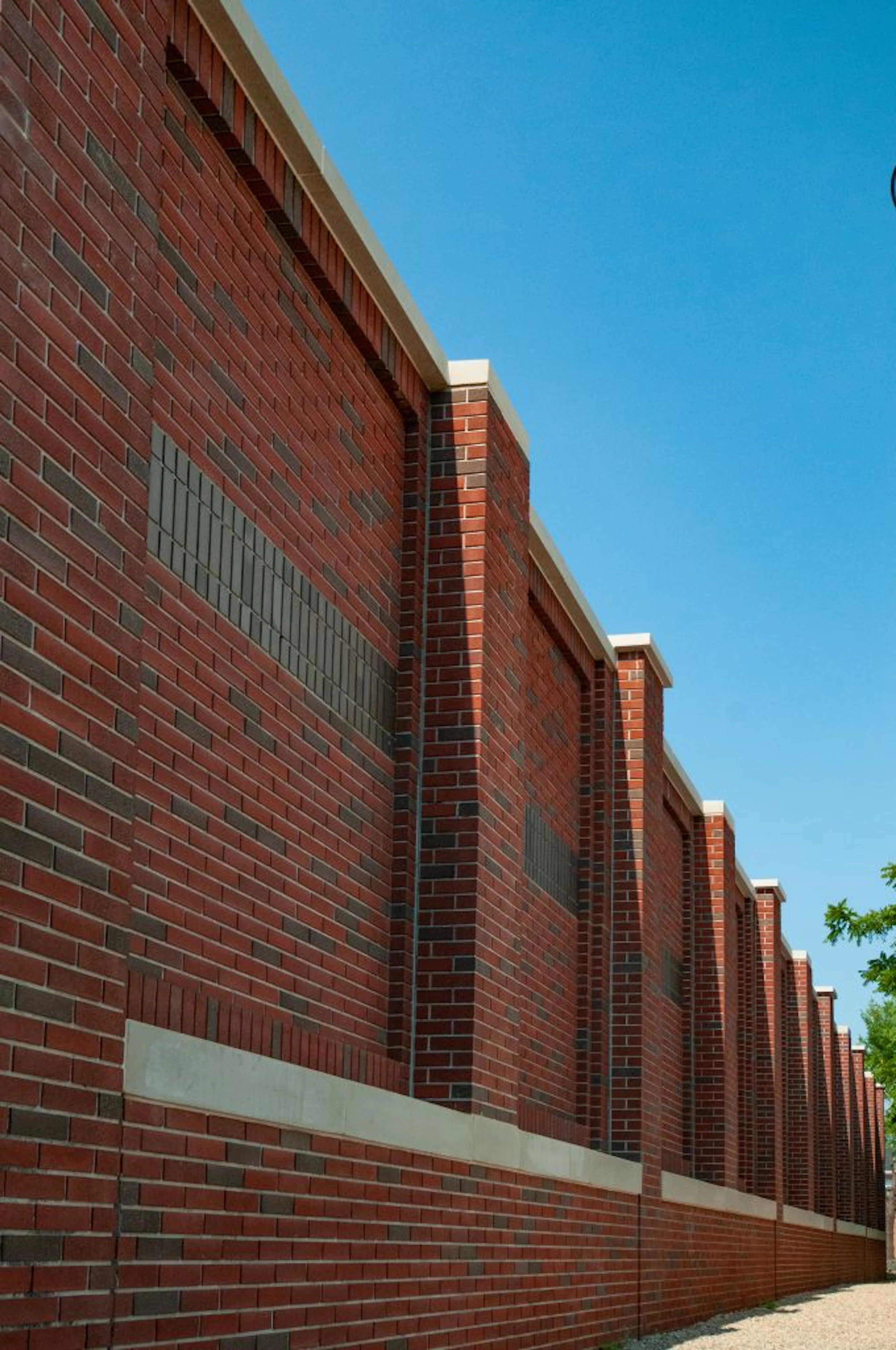 Brick-Patterned Perimeter Wall Blends Into Greenwich