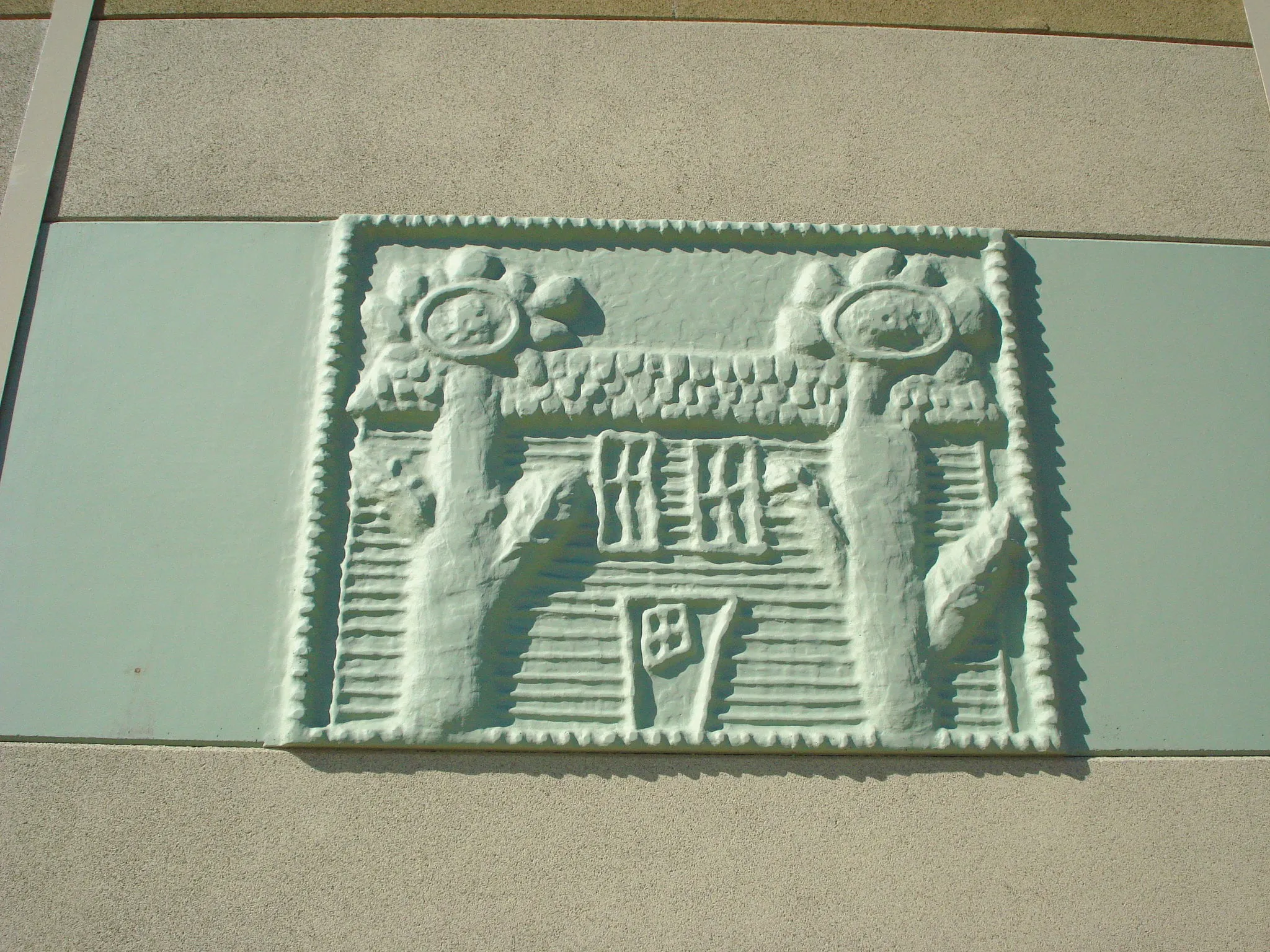 Close-up of a Clary Sage icon panel molded from a drawing of a house between two sunflowers