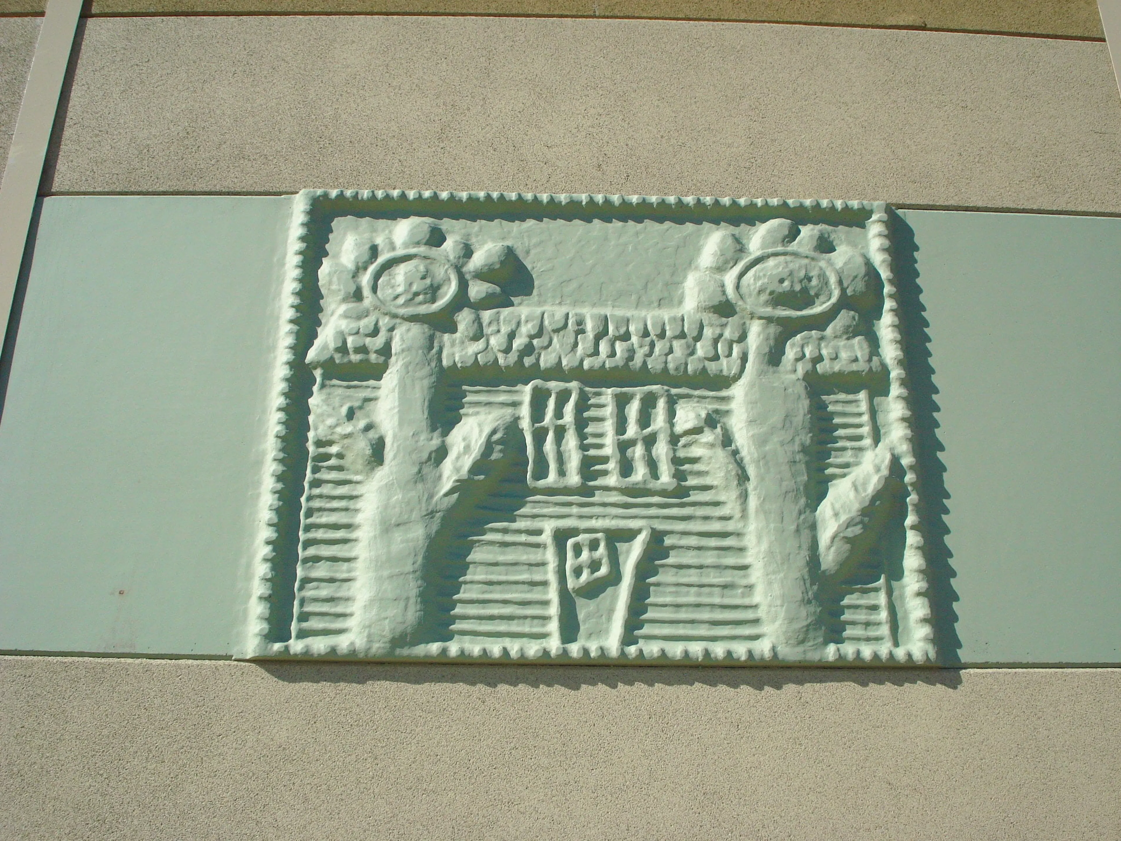 Close-up of a Clary Sage icon panel molded from a drawing of a house between two sunflowers