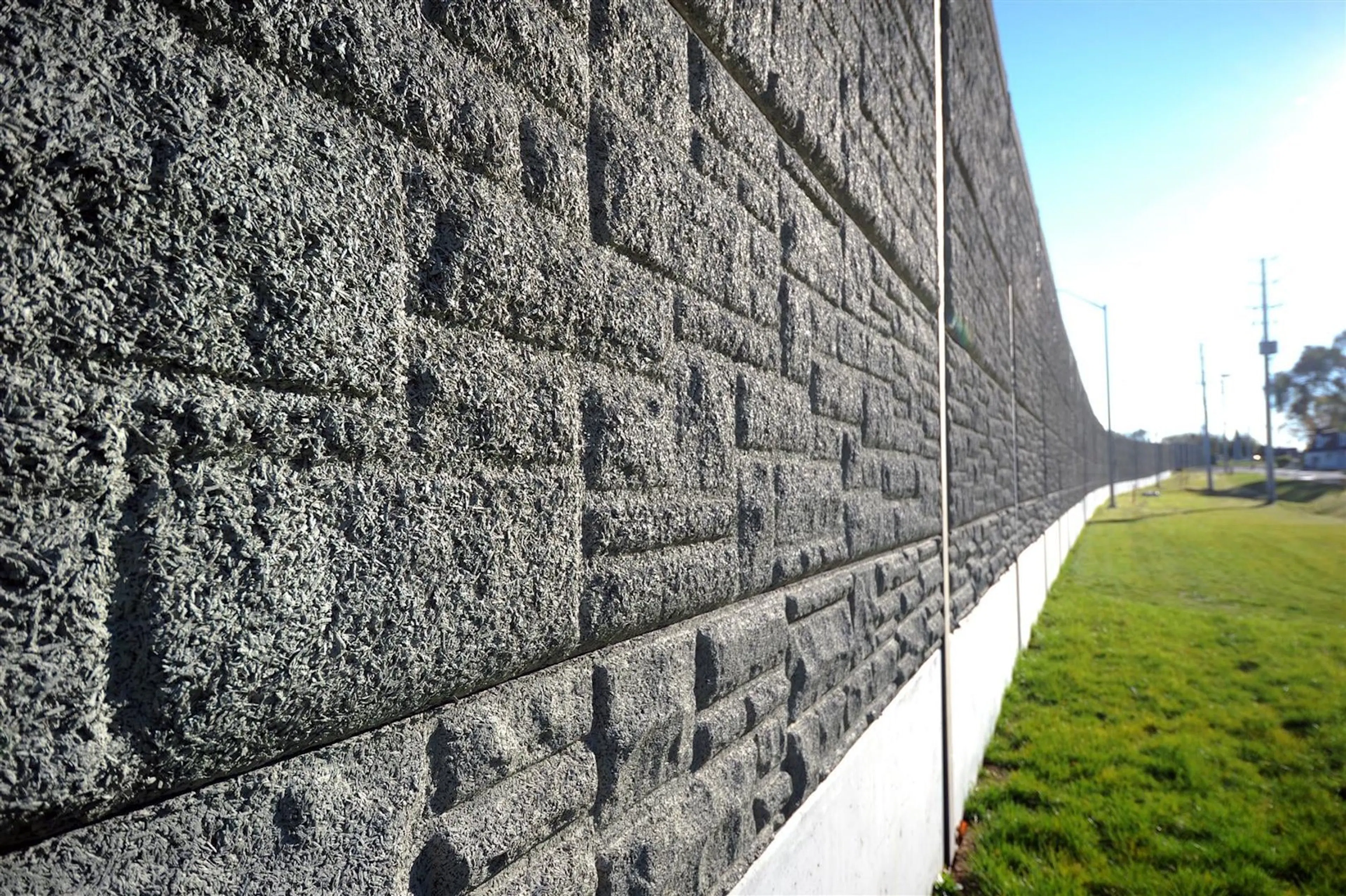 Close view along the deeply textured face of the absorptive perimeter wall