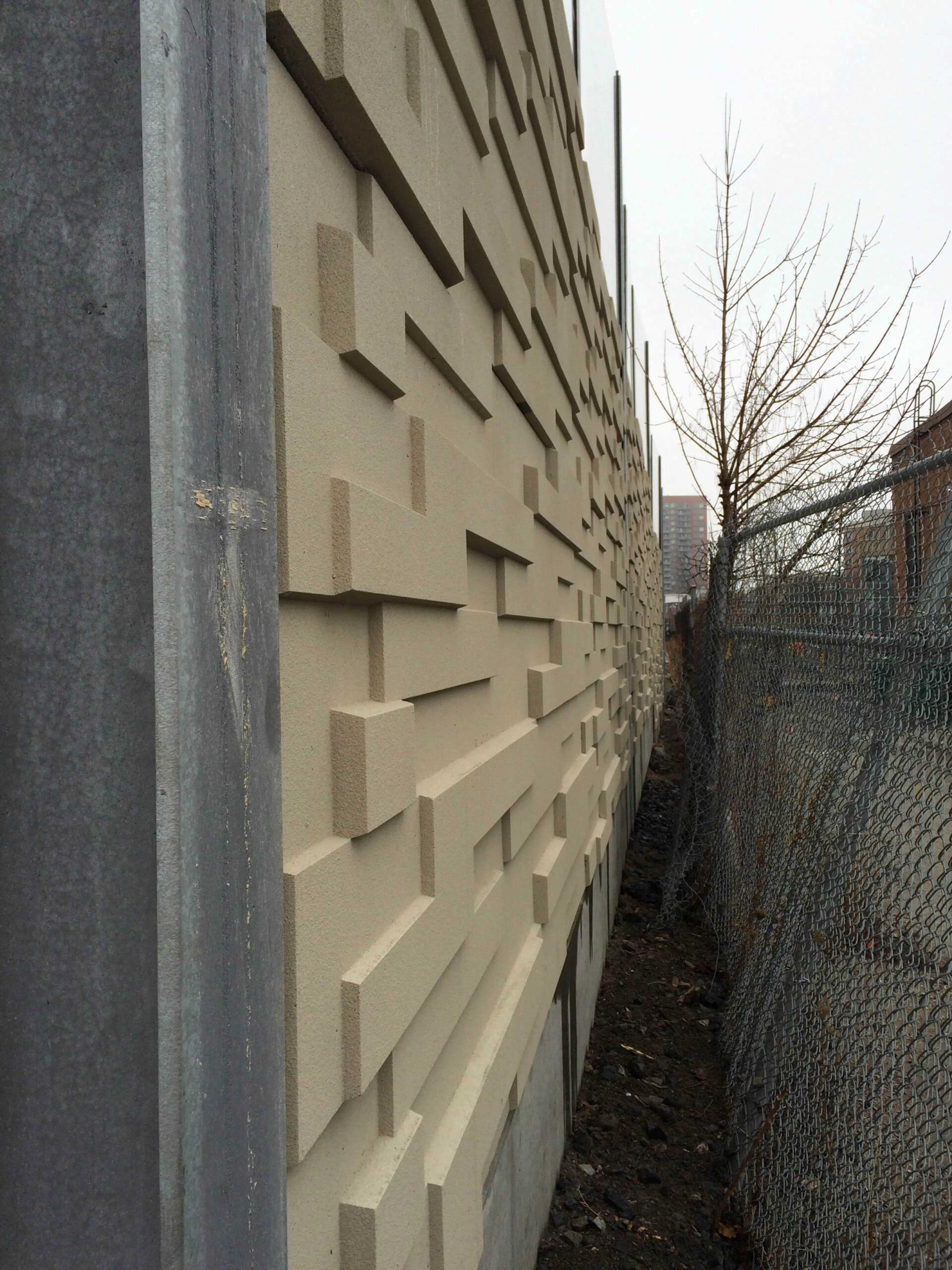 Close view of the staggered relief blocks cast into the UP Express wall panels