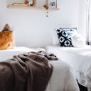 Deux lits simples avec des coussins colorés