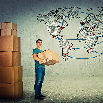 Un homme tenant un carton à côté d'une carte du monde qui déménage à l'international