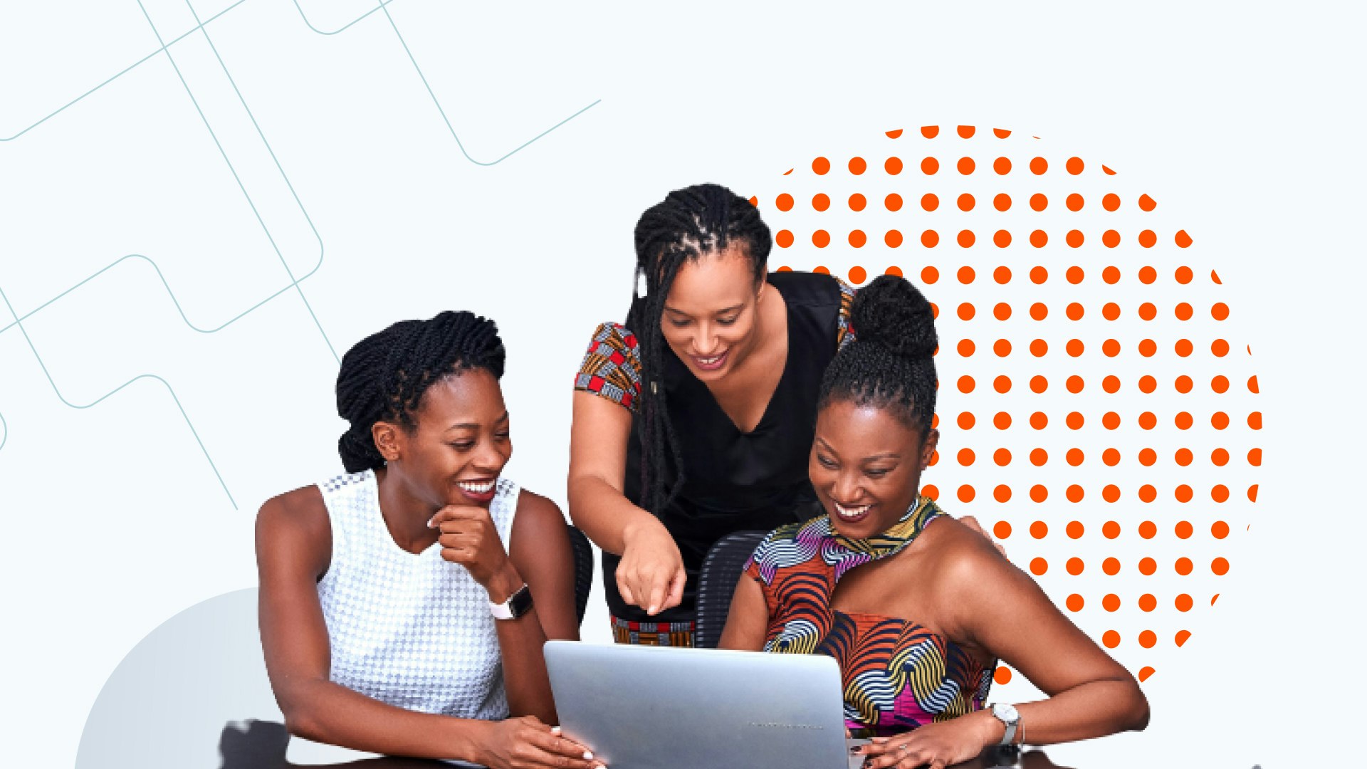A group of Black women professionals working together at a laptop