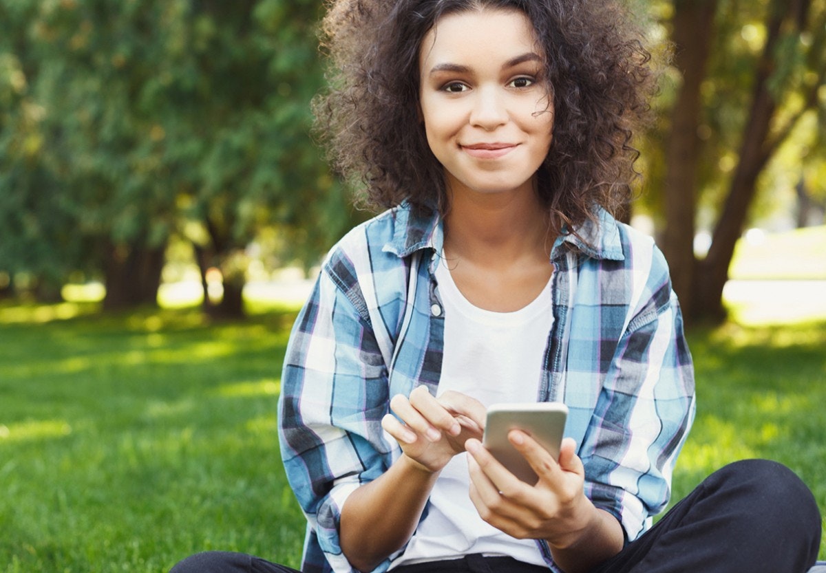 A photo of a student using their phone to apply to a school