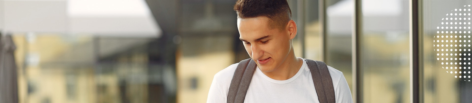 Male student looking at a cell phone.