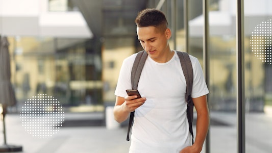 Male student looking at a cell phone.