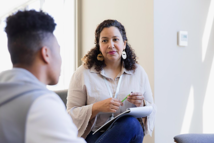 Admission counselor talking with a prospective student. The college enrollment funnel.
