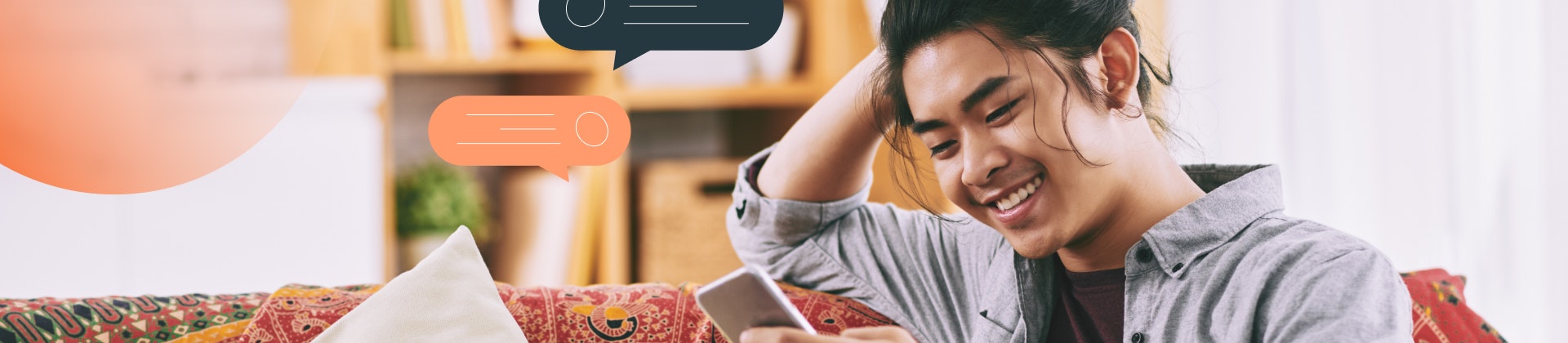 A student looking at his phone and smiling. Text bubble graphics surround him.