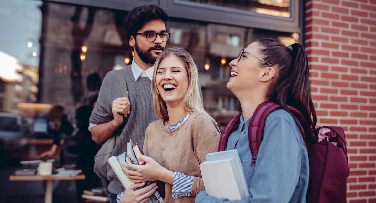 A group of students excited to arrive on campus.