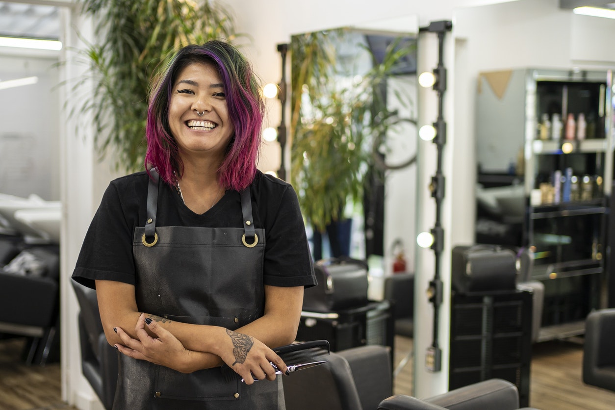Portrait of hairdresser with dye hair at hair salon