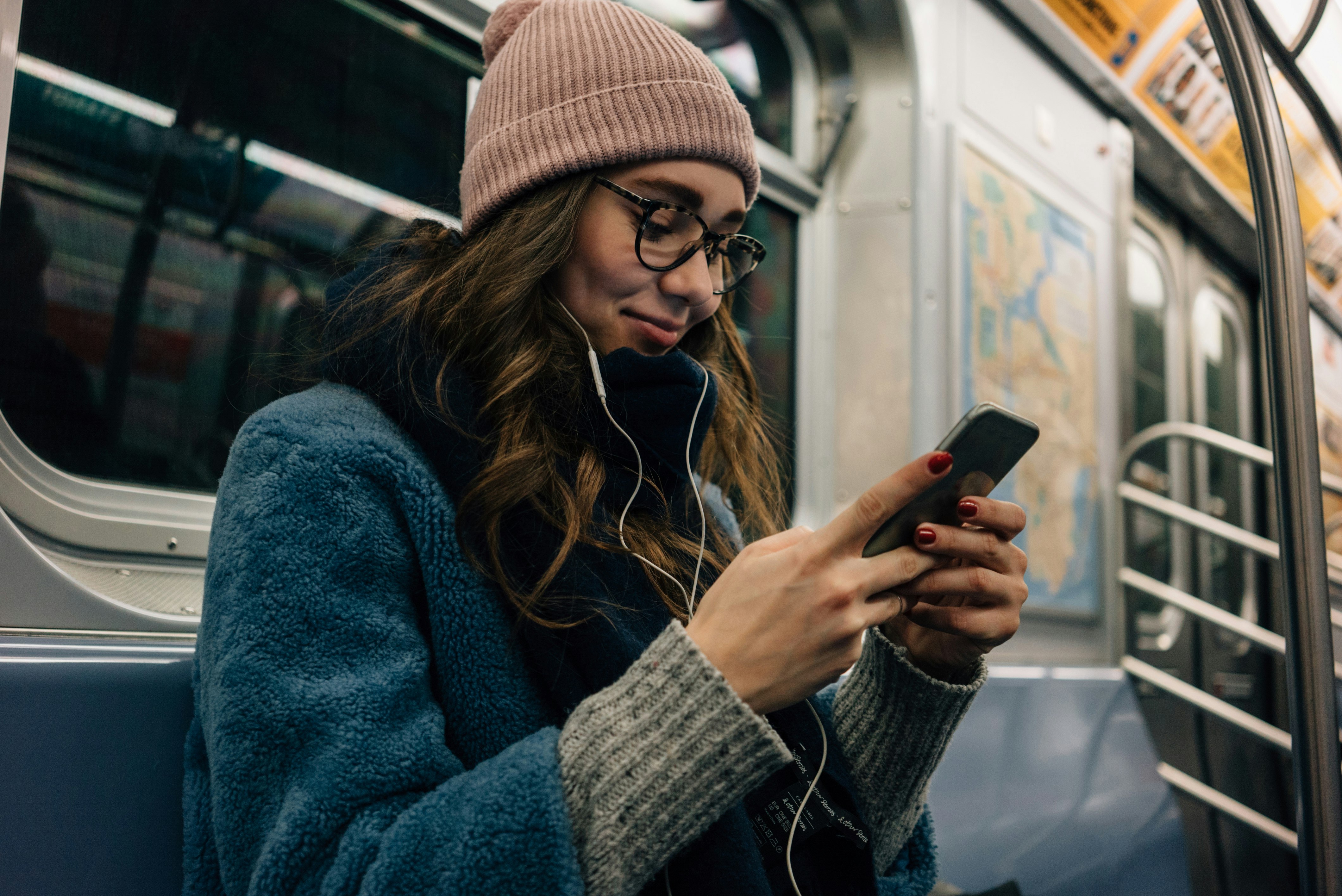 Girl looking at her phone screen on the subway