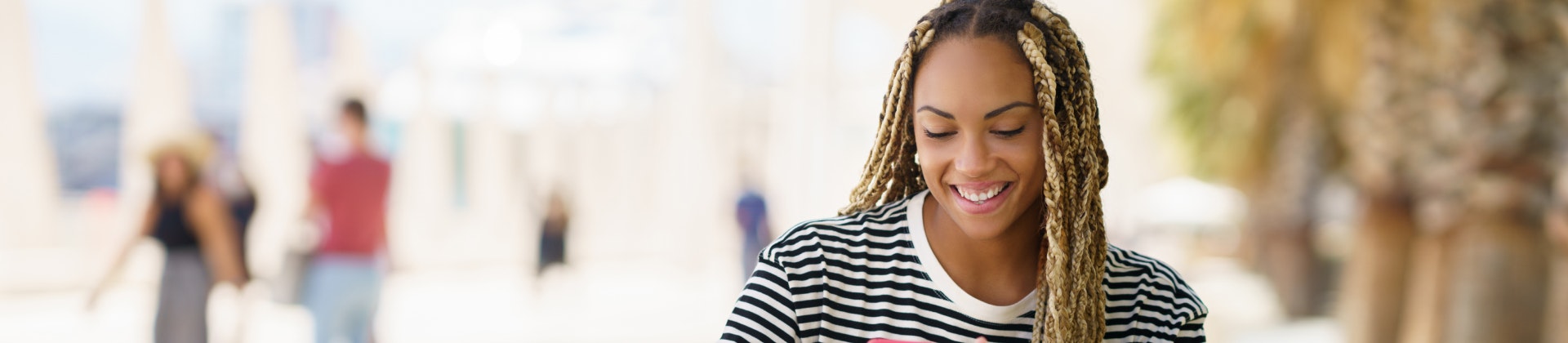 Young girl on her cell phone smiling.