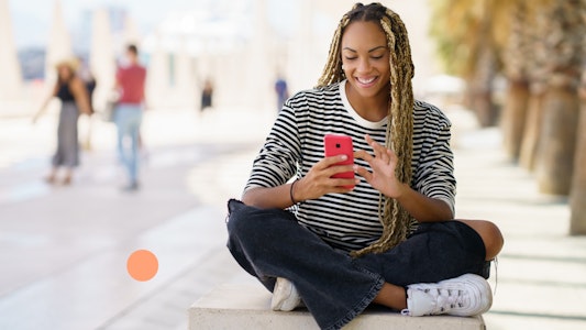 Young girl on her cell phone smiling.