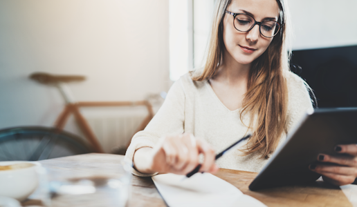 Young woman working on homework with a tablet. What is student success in higher education?