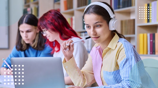 Student with headphones looking at her laptop.
