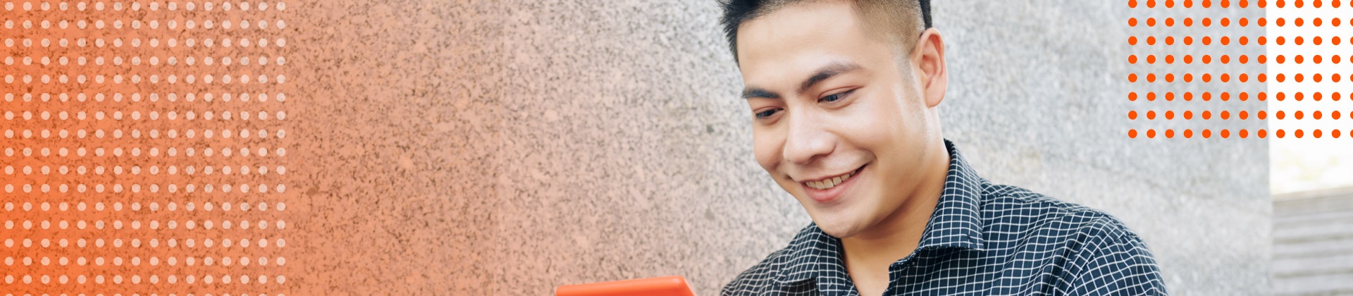 Male student smiles working on a tablet.