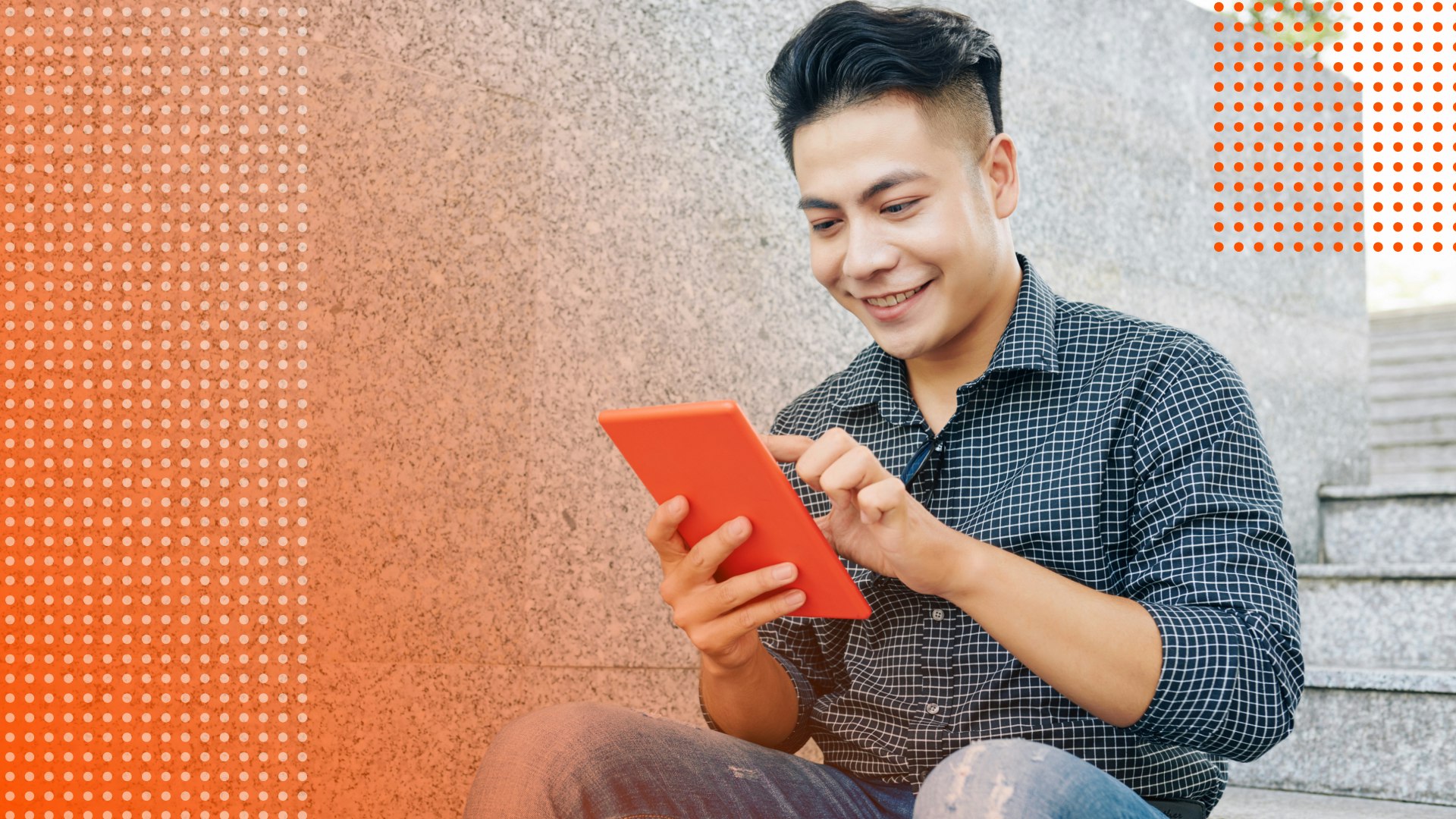 Male student smiles working on a tablet.