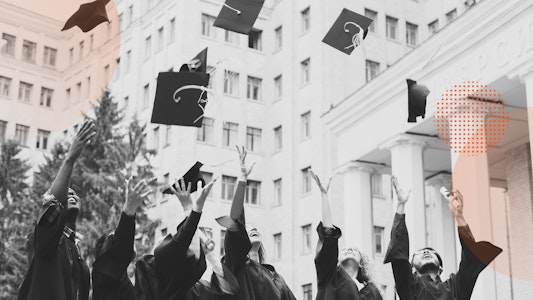 Group of students tossing graduation caps into the air