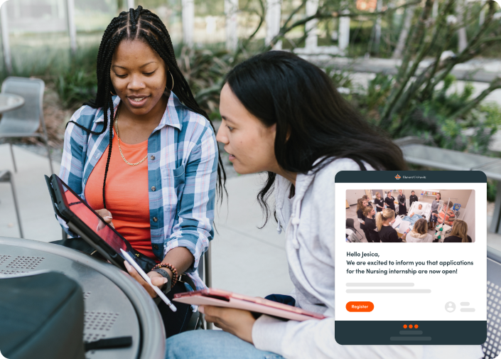 Two female students looking at their iPads. They are reading a personalized email that alerts them that Nursing applications are now open.