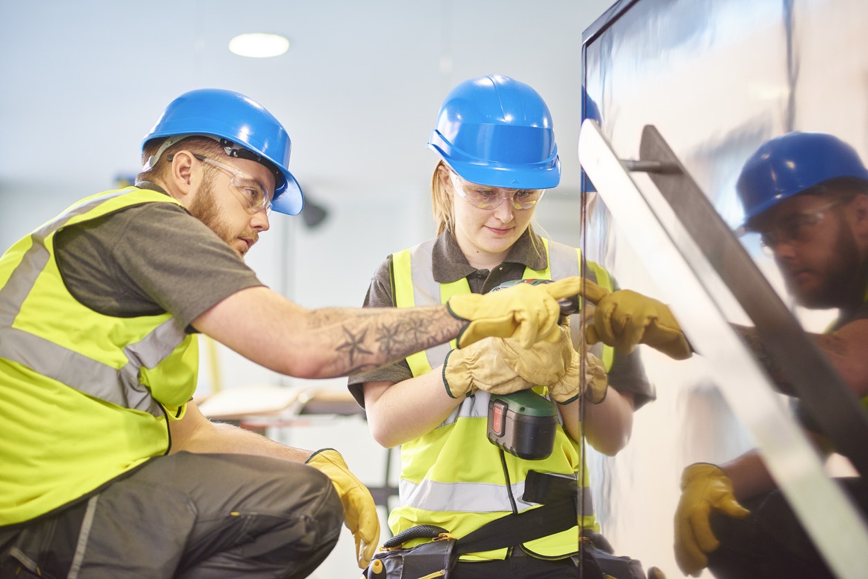 Female construction apprentice and colleague stock photo