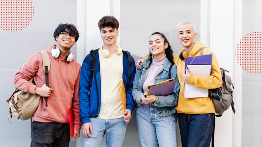 A group of students with headphones, binders and backpacks.