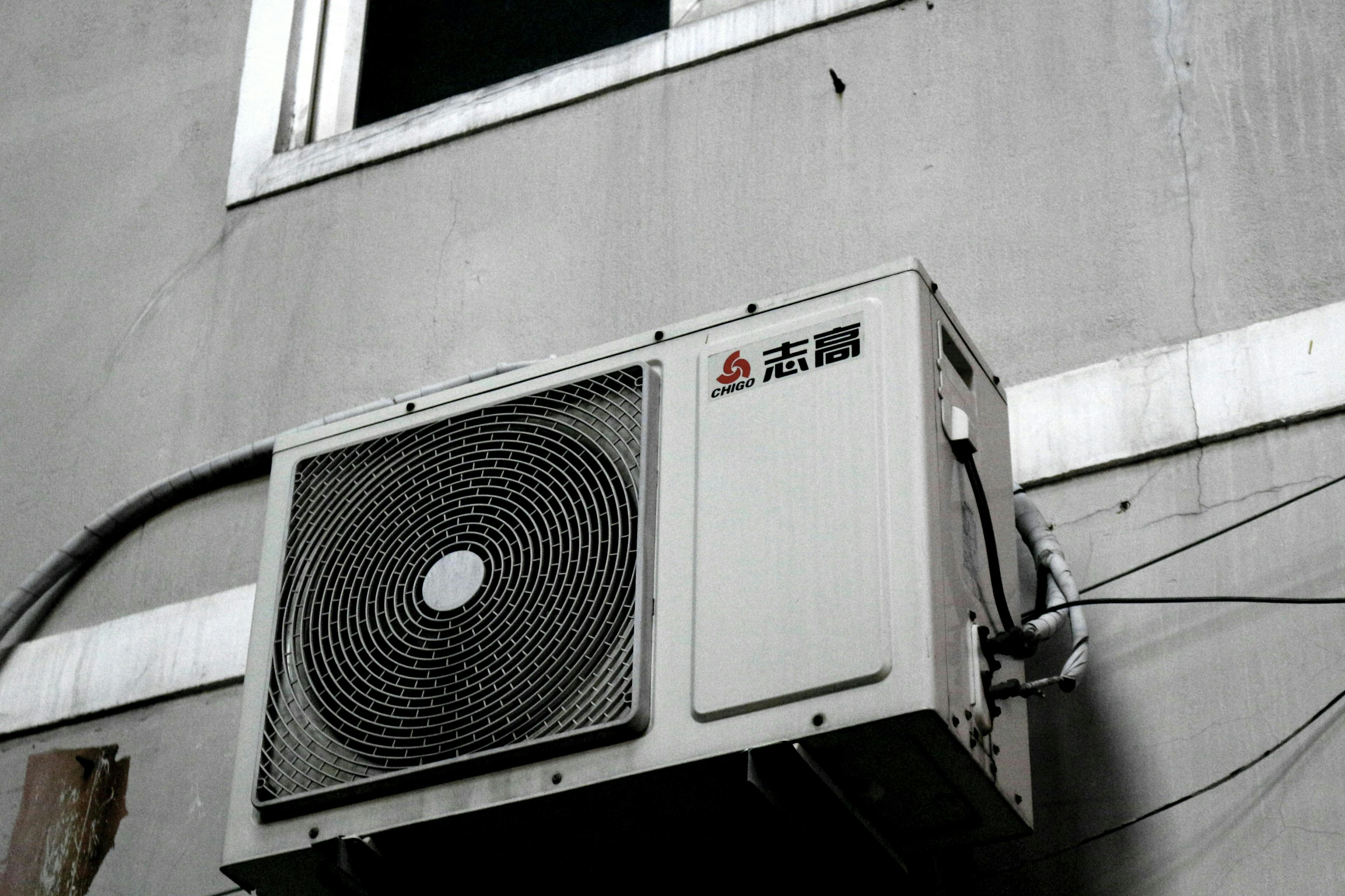 Air Source Heat Pump on a grey wall 