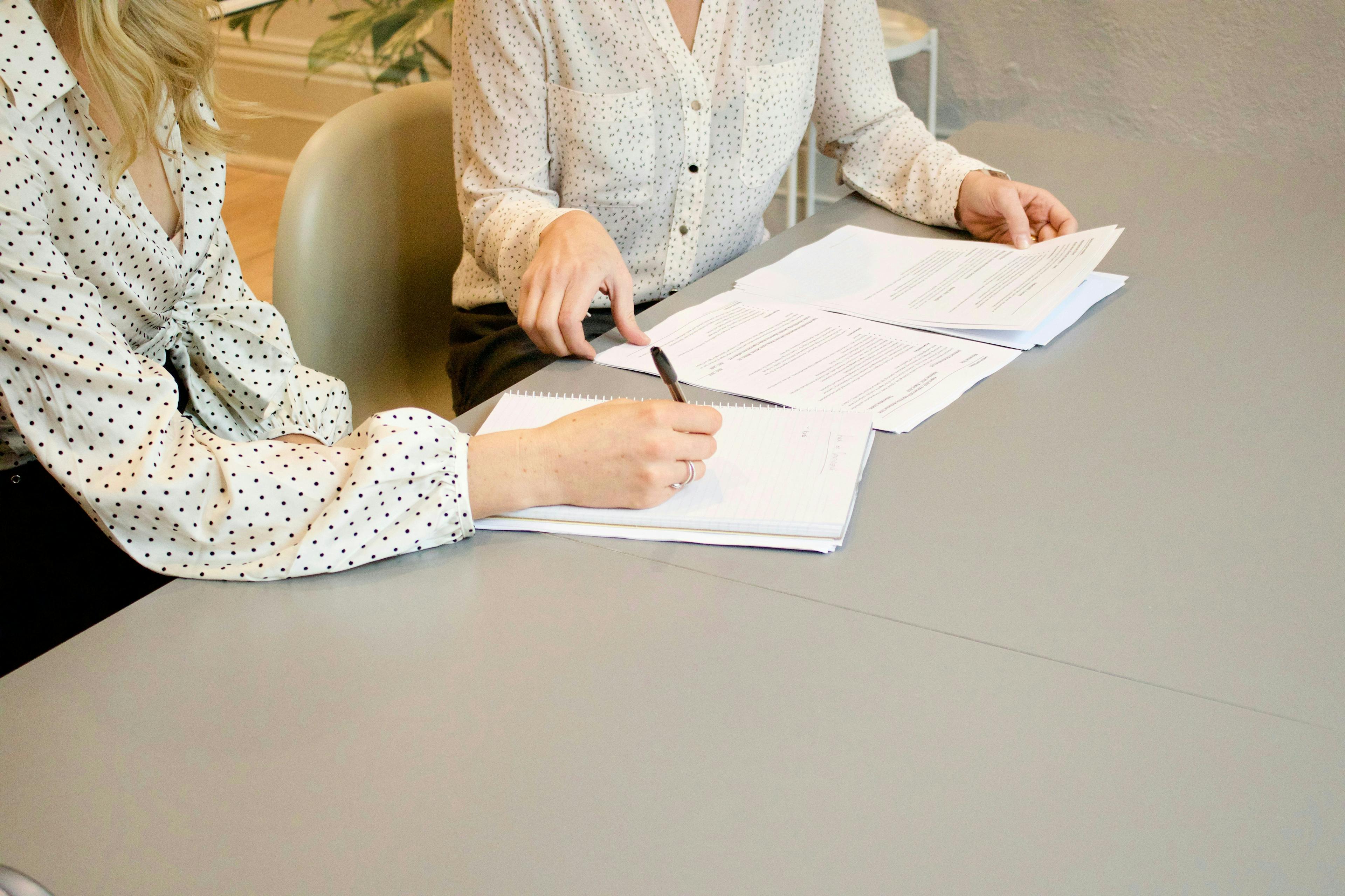 A woman signing a paper work