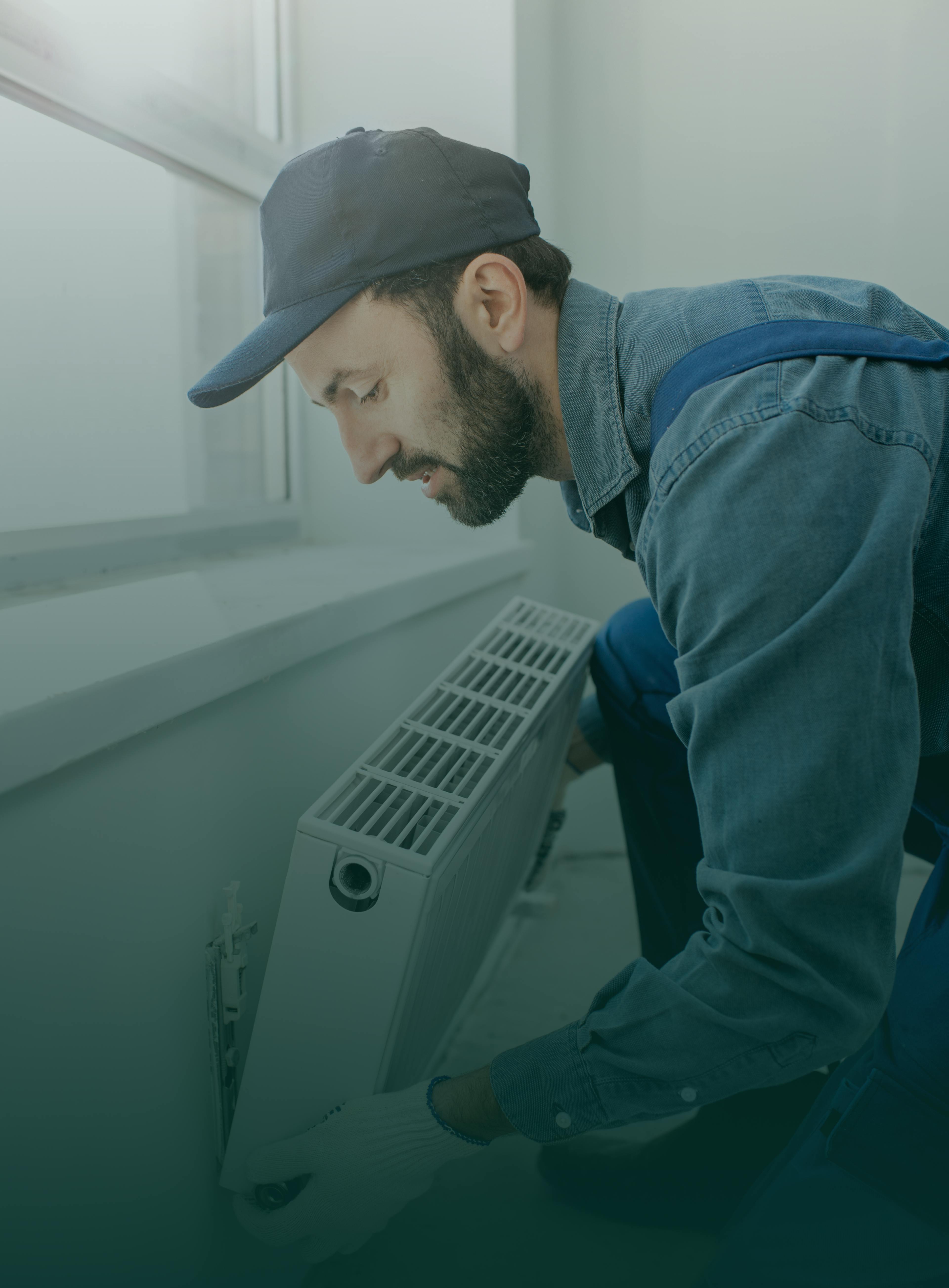 maintenance guy fitting a radiator