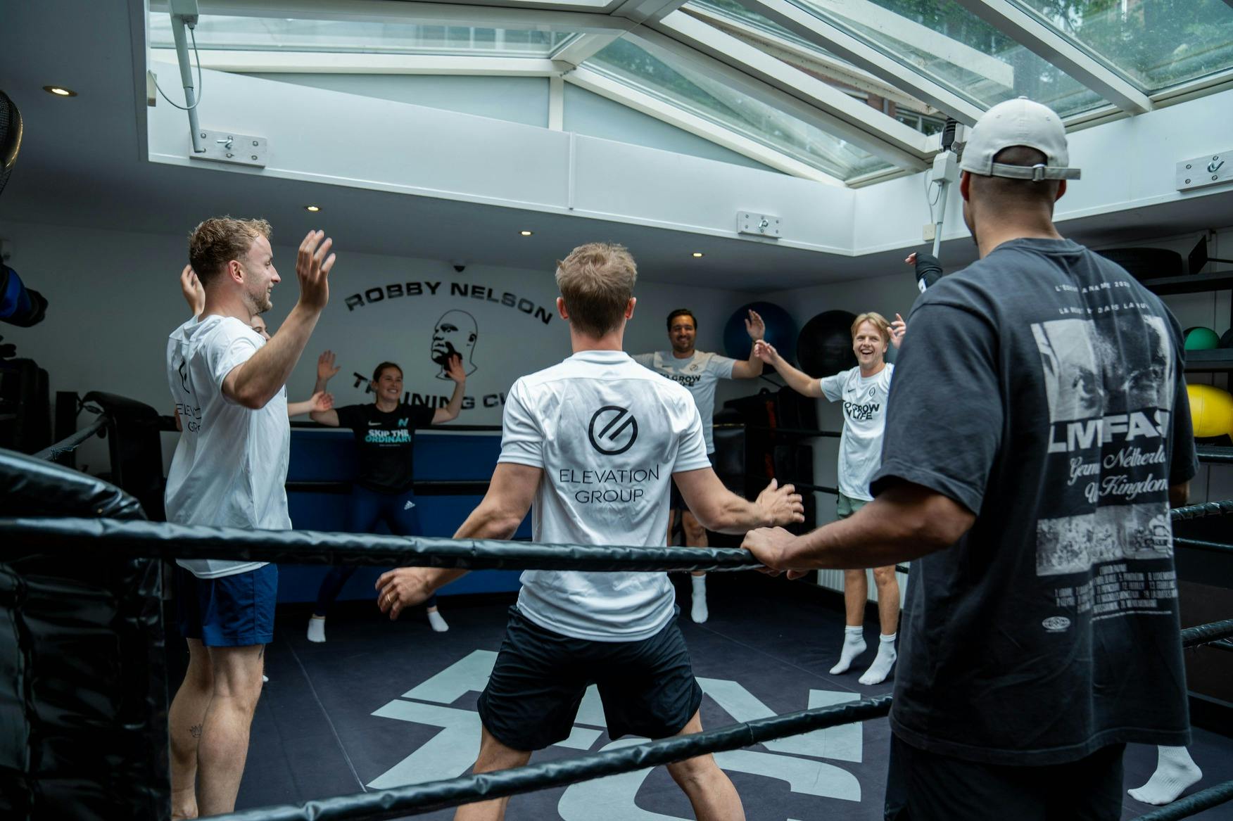Werknemers in een boxring tijdens een boksclinic van kampioen Levi Rigters.