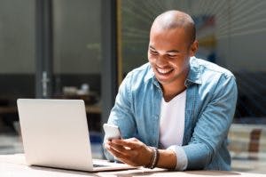 https://images.prismic.io/elevenrush/2140aaa2-2f03-4fc2-b2de-854ec0cc94f1_young-happy-man-smiling-and-holding-a-smartphone-sitting-outdoor-with-laptop-1-scaled-1-300x199.jpg?auto=compress,format