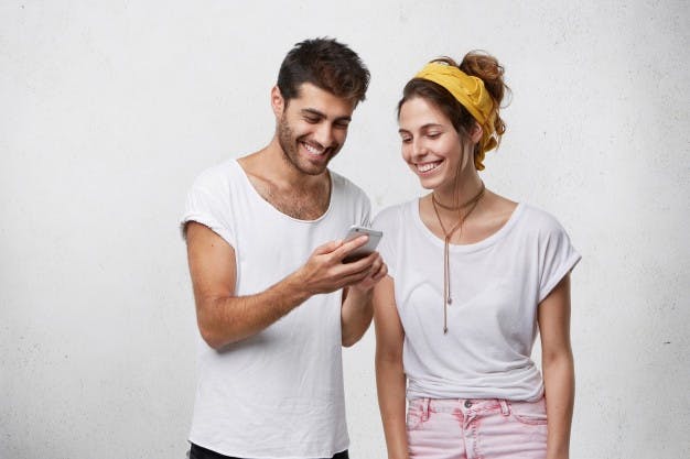 https://images.prismic.io/elevenrush/fda85976-1c5a-453b-92c3-687937627f40_happy-young-bearded-hipster-holding-smart-phone-showing-his-girlfriend-funny-pictures-videos-relaxed-carefree-european-couple-using-high-speed-internet-connection-electronic-device-together_273609-7993.jpg?auto=compress,format