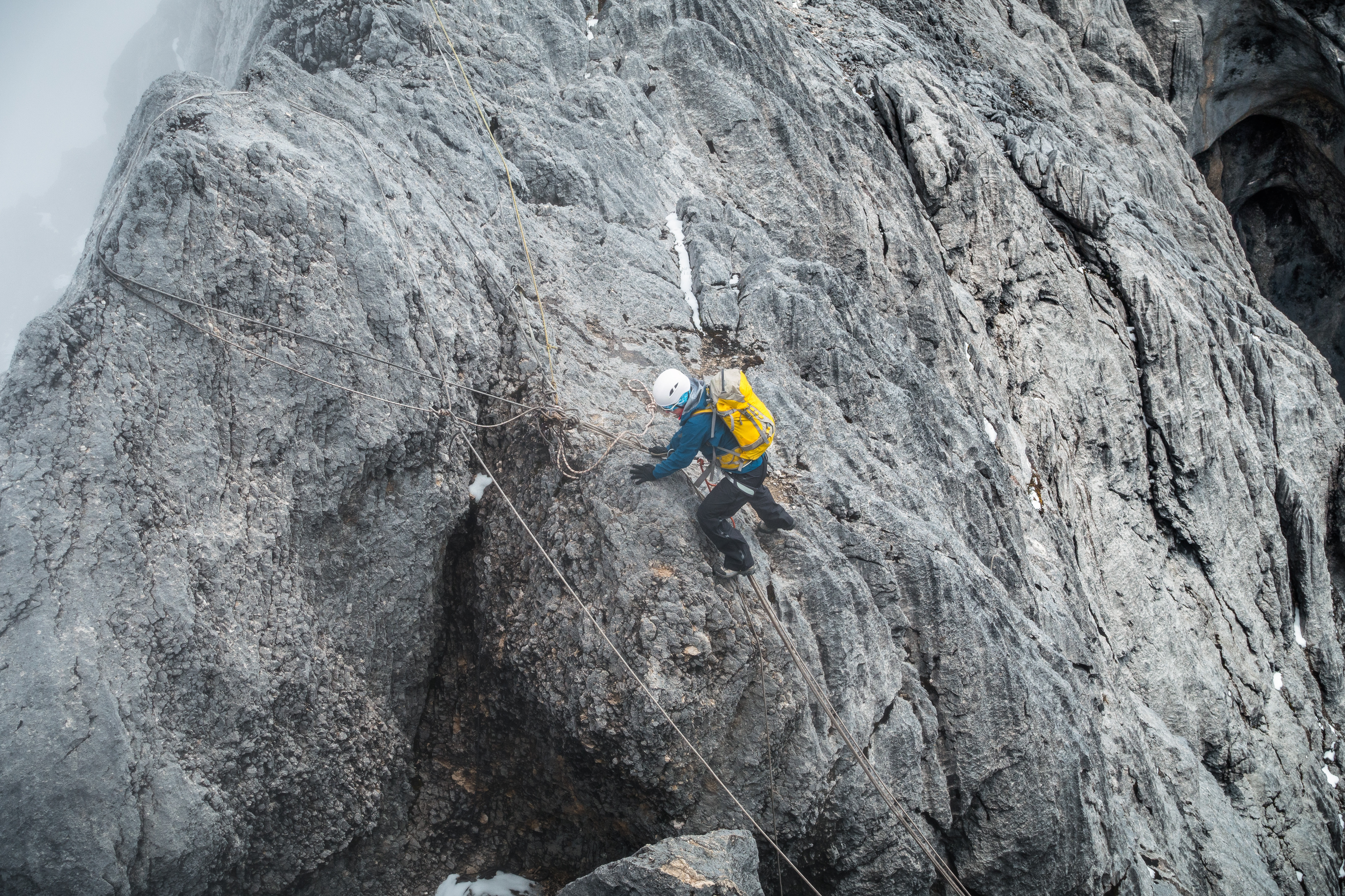 Climber negotiating difficult rock section during ascend of Carstrnsz Pyramid